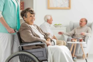 Adult daughter reviewing a care plan with an older parent at a table in an assisted living room
