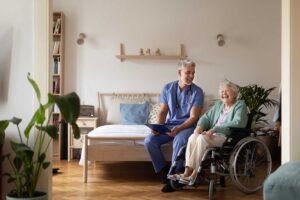 Older residents perform gentle balance exercises in a bright assisted living activity room.